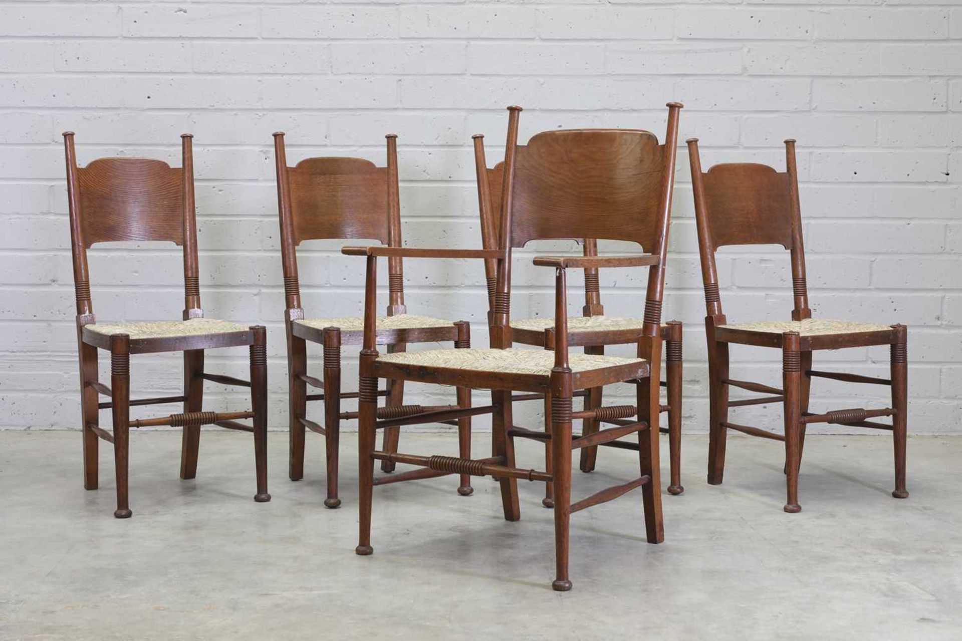 A set of four Arts and Crafts elm dining chairs,