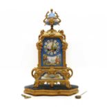 A gilt spelter and porcelain mantel clock and stand,