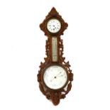 A Victorian carved oak aneroid barometer,