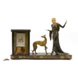 An Art Deco ivory mounted figural spelter clock,