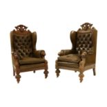 A pair of late Victorian carved oak wing armchairs,