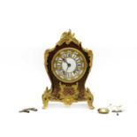 A red Boulle mantel clock,