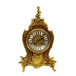 A red boulle mantel clock,