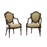 A pair of Louis XVI style mahogany elbow chairs