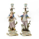 A pair of porcelain Meissen style figural candelabrum,