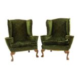 A pair of large wingback armchairs,