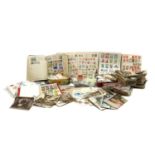 A quantity of mixed world stamps and postcards,