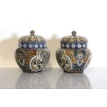 A pair of Doulton Lambeth tobacco jars, lids and covers,