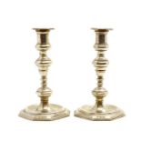 A pair of cast silver candlesticks,