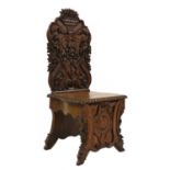 A carved oak hall chair,