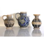 Two Doulton Lambeth stoneware jugs and a vase,