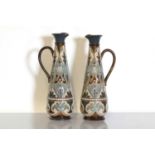 A pair of Doulton Lambeth stoneware ewers,