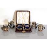 A cased set of four Doulton Lambeth stoneware cruets