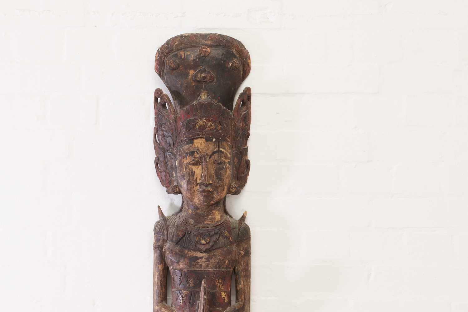 A polychrome painted carved wood figure,