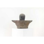 A carved granite lingam and yoni,