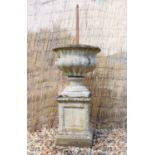 A reconstituted stone pedestal garden urn and stand