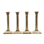 A set of four silver candlesticks