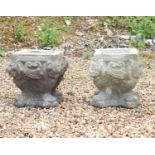 A pair of composite stone planters