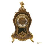 A tortoiseshell and brass mantel clock,