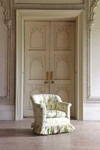 A button-upholstered tub chair by Howard & Sons,