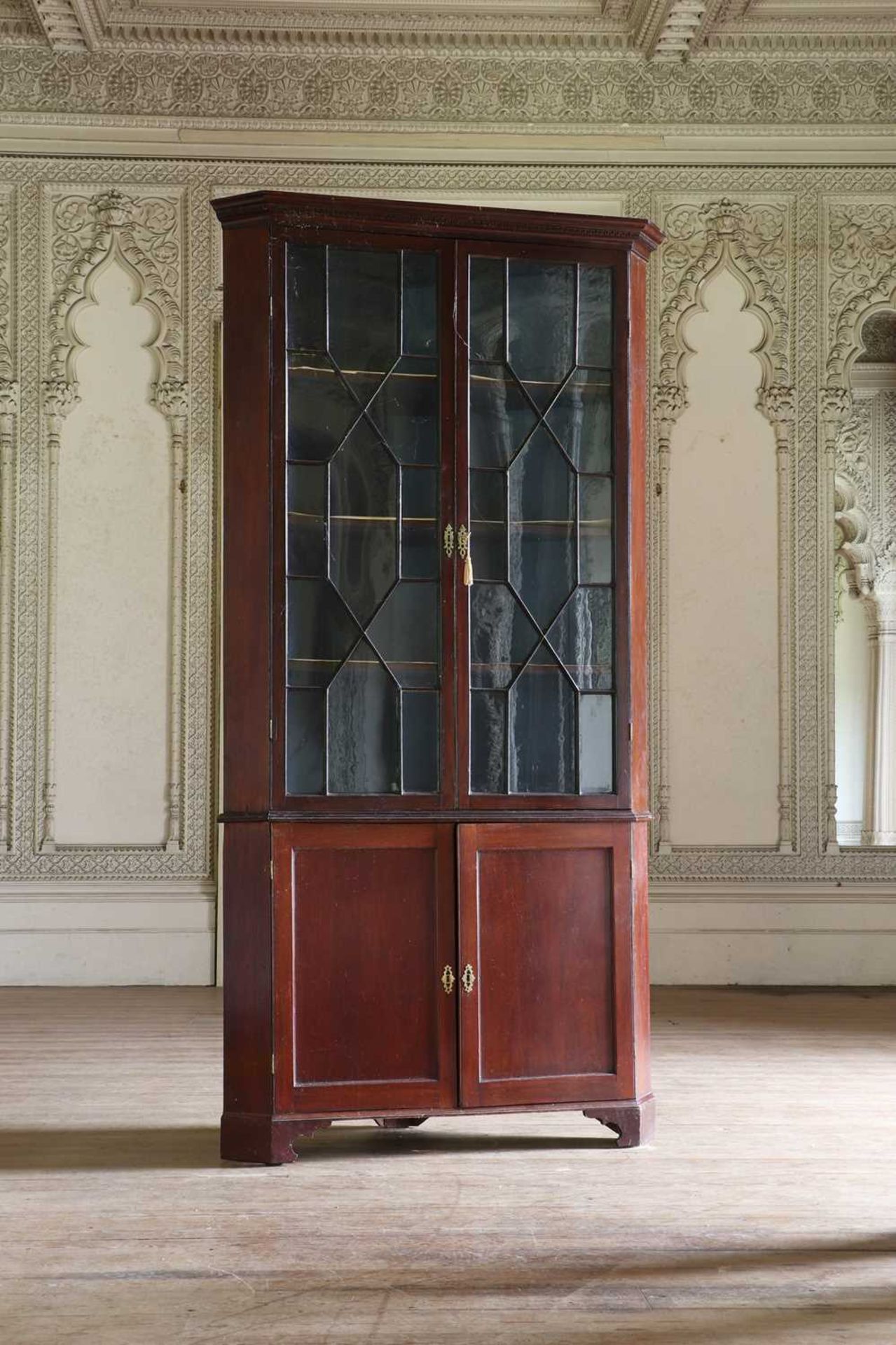 ☘ A George III mahogany standing corner cupboard,
