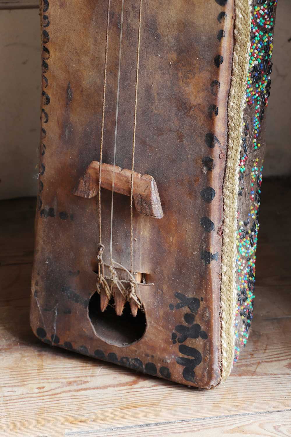 A three-stringed instrument, - Image 6 of 8