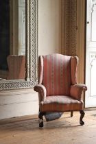 A mahogany George III-style wingback armchair,