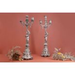 A pair of classical-style silver-plated candlesticks,