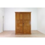 A blonde oak compactum wardrobe,