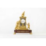 An Empire gilt and patinated bronze mantel clock,