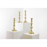 A collection of brass candlesticks,