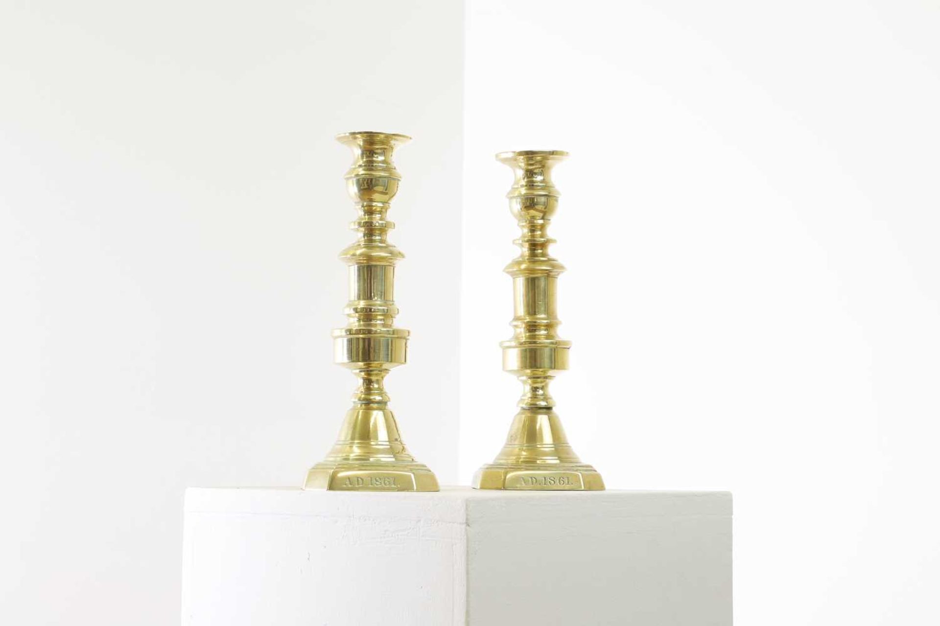 A pair of Victorian brass candlesticks,