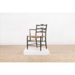 An ebonised wooden elbow chair,