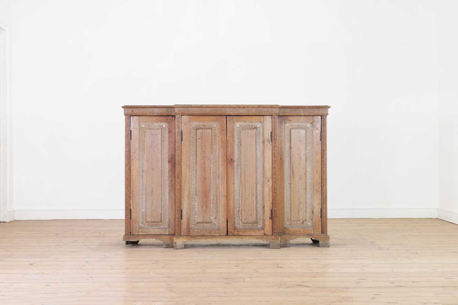 A George II-style carved pine breakfront side cabinet,