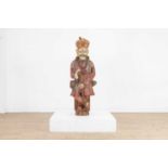 A Rahjastani carved wooden figure of a man,