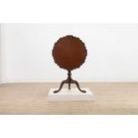 A George III-style carved mahogany tripod table
