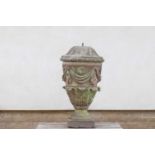 A large carved stone urn and cover,