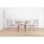 A painted wrought-iron table and chairs,