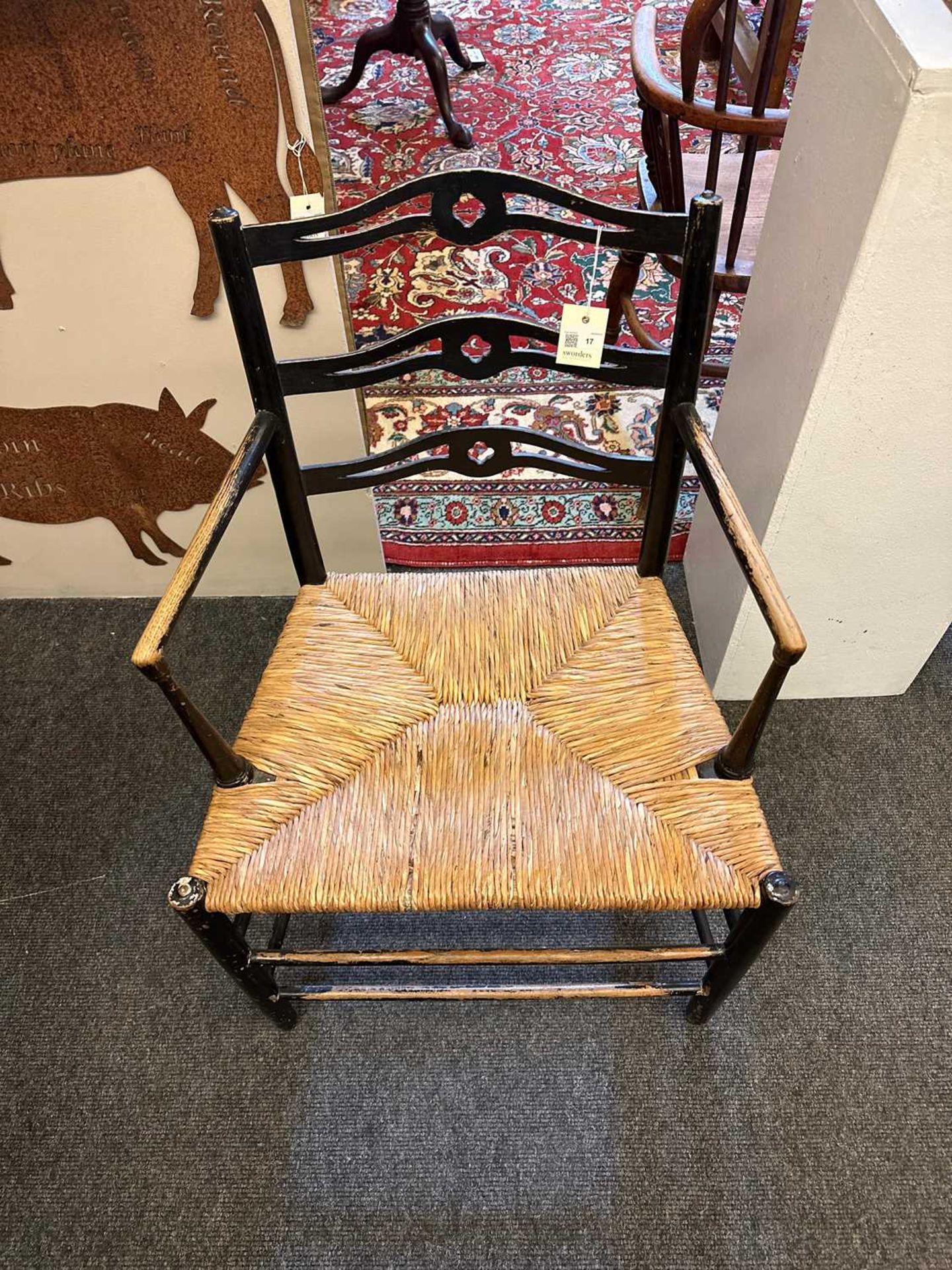 An ebonised wooden elbow chair, - Image 7 of 20