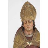 A carved and polychrome-painted pine figure of a saint