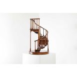 A turned wooden model of a staircase,