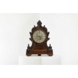 A Victorian carved bracket clock,
