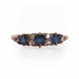 A graduated three stone sapphire boat shaped ring,