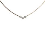 A gold three stone diamond necklace,