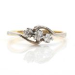 A gold crossover design three stone diamond ring,