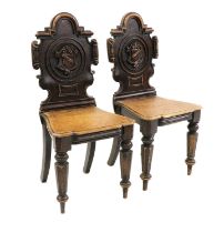 A pair of Victorian oak hall chairs