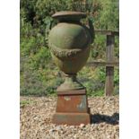 A cast iron amphora urn and stand