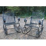 A pair of wrought iron garden rocking chairs