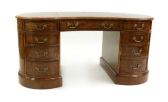 A burr walnut kidney shaped pedestal desk