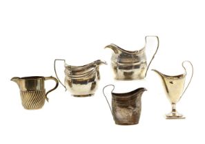 A group of five silver cream jugs